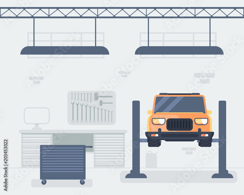 Car repair shop interior. Car on lift platform.