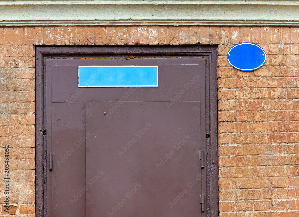The nameplate on the house on the street. A sign on the stone wall outside on the street. The nameplate on the house on the street. A sign on the stone wall outside on the street.