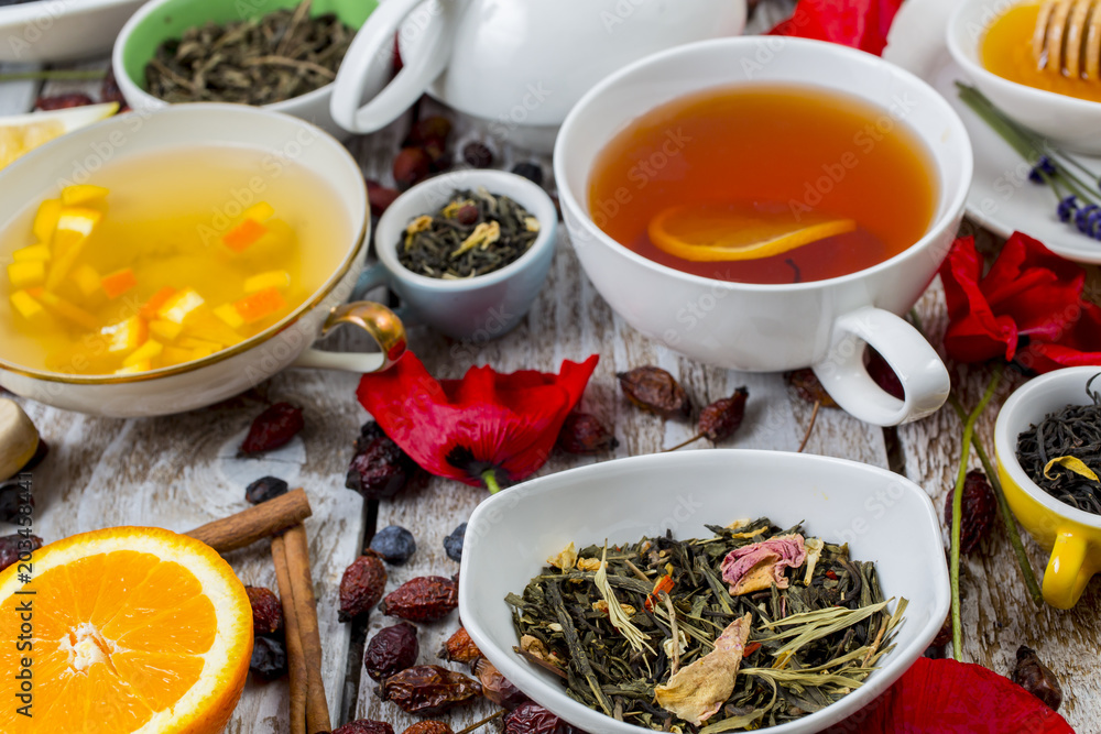 Various leaves of tea and spices on wooden background Various leaves of tea and spices on wooden background