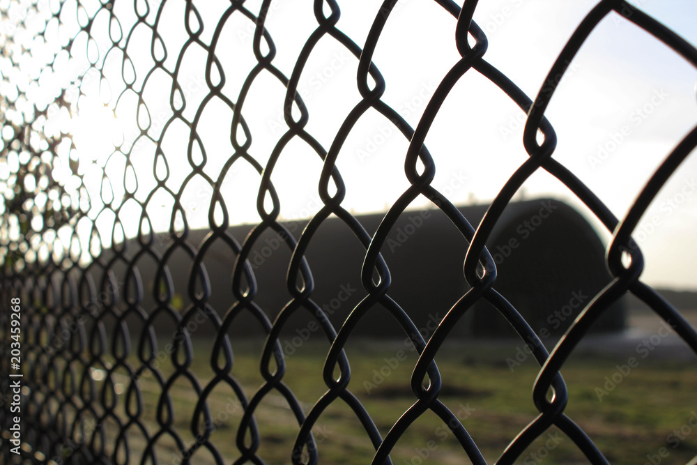 Fototapeta premium Close up shot of a chainlink fence on the border of Rendlesham Air Force base, UK