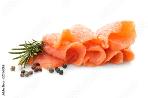 Fresh sliced salmon fillet with rosemary and pepper mix on white background