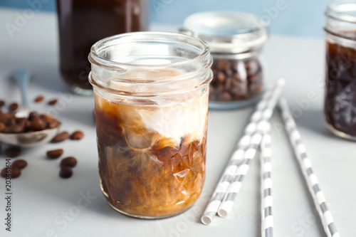 Billede på lærred Jar with cold brew coffee and milk on table