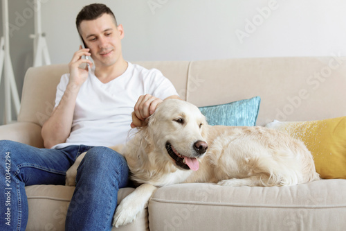 Portrait of owner with his friendly dog at home