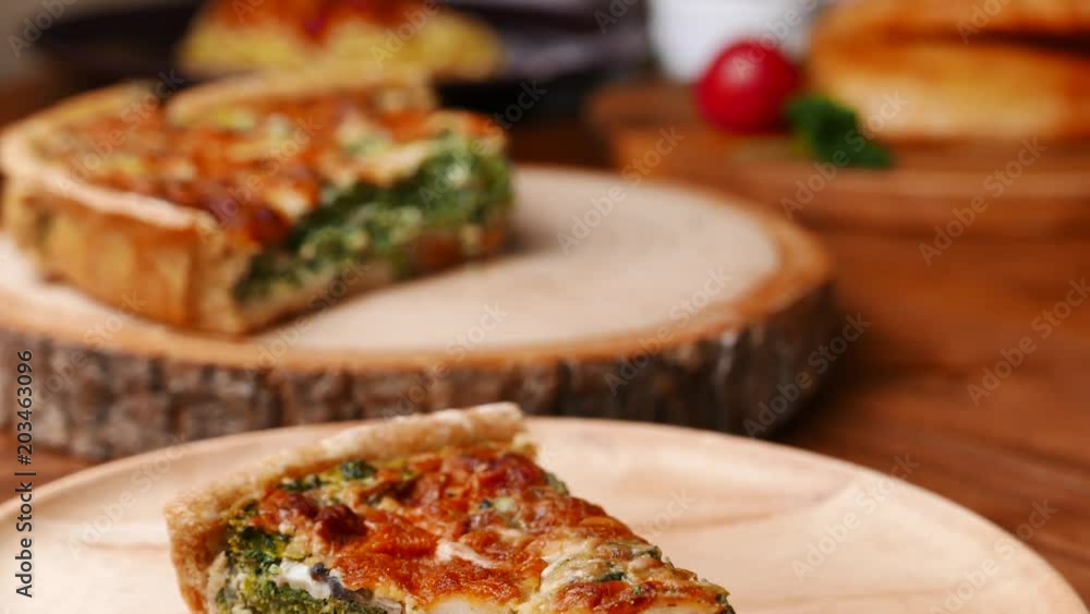 Quiche a savoury open tart or flan consisting of pastry crust with spinach mushrooms cheese. Quiche a savoury open tart or flan consisting of pastry crust with spinach mushrooms cheese.