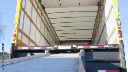 Low angle of a ramp and moving truck in 4k. Wide shot of the empty truck represents relocating for work, a fresh start and transplantation. 