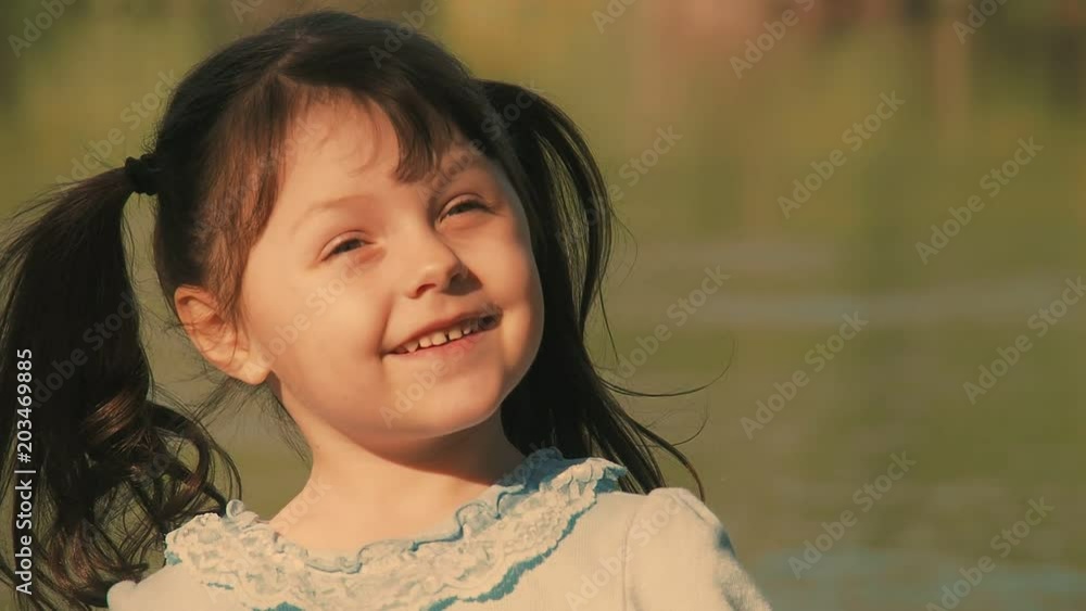 Portrait of a happy child. Beautiful little girl on nature. Portrait of a happy child. Beautiful little girl on nature.