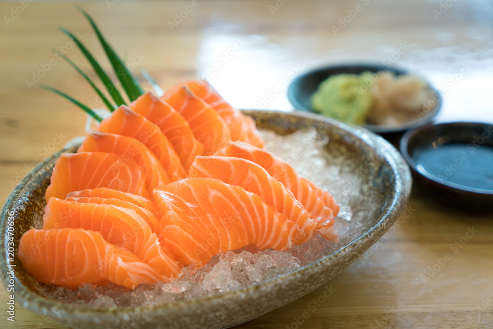 Raw salmon slice or salmon sashimi in Japanese style fresh serve on ice in bowl. Raw salmon slice or salmon sashimi in Japanese style fresh serve on ice in bowl.
