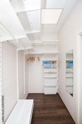 Inside of the empty white walk-in wardrobe