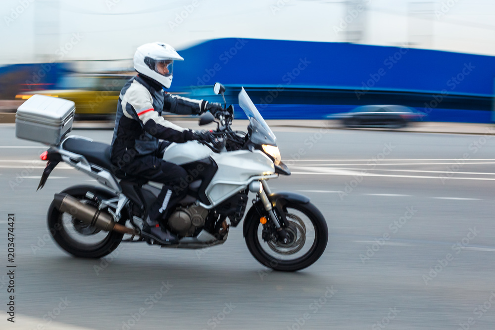 motorcycle rides with speed on city roads