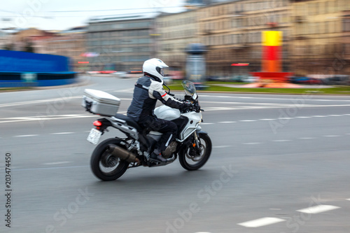 motorcycle rides with speed on city roads