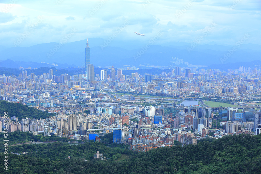 Aerial panorama of Taipei downtown & suburbs at dusk with view of Keelung Riverside Park, MacArthur bridge, Taipei 101 in Xinyi District ~ A romantic night in busy Taipei City in a gloomy blue mood