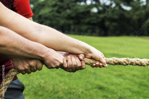 Fotografie Team competing in tug of war
