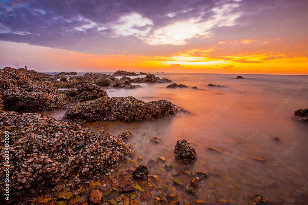 Evening light by the sea. (Laem Chabang Beach), sea change color Always find a photographer to capture beautiful. There are fishermen who come fishing along the coast. Chonburi Province, Thailand Evening light by the sea. (Laem Chabang Beach), sea change color Always find a photographer to capture beautiful. There are fishermen who come fishing along the coast. Chonburi Province, Thailand