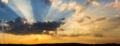 Amazing dramatic sunset, with sunbeams shining throught the clouds