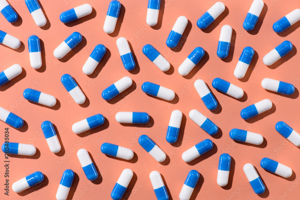 top view of pills on orange tabletop