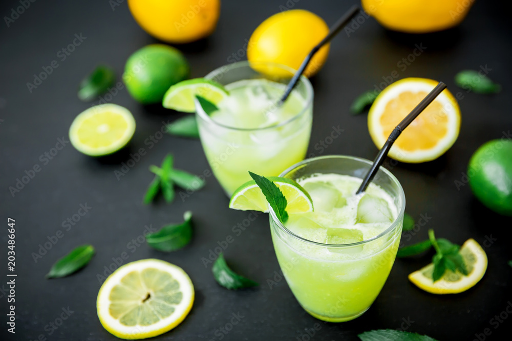 Glass of refreshing lemonade with limes and lemons Glass of refreshing lemonade with limes and lemons