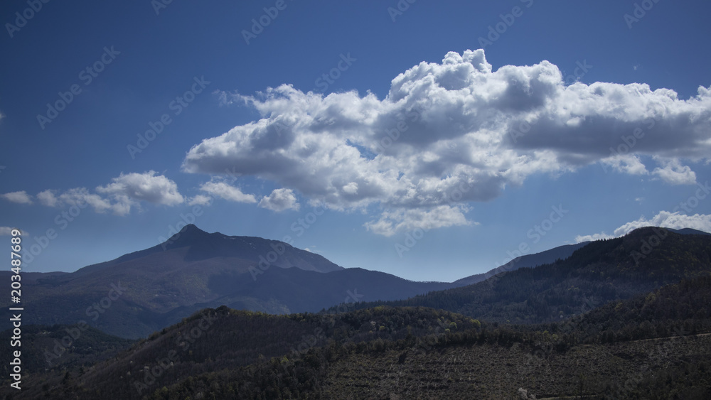 Mountain blue landscape on a blue sky with some clouds