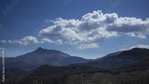 Mountain blue landscape on a blue sky with some clouds