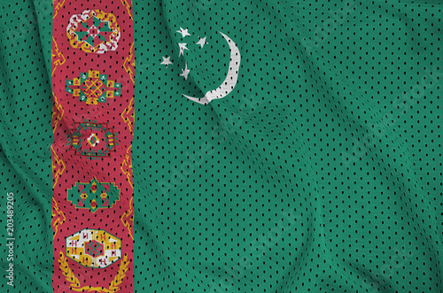 Turkmenistan flag printed on a polyester nylon sportswear mesh fabric with some folds photo