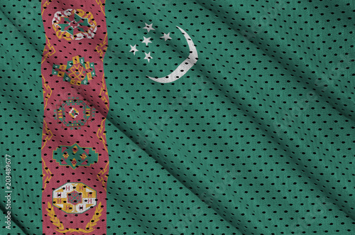 Turkmenistan flag printed on a polyester nylon sportswear mesh fabric with some folds photo