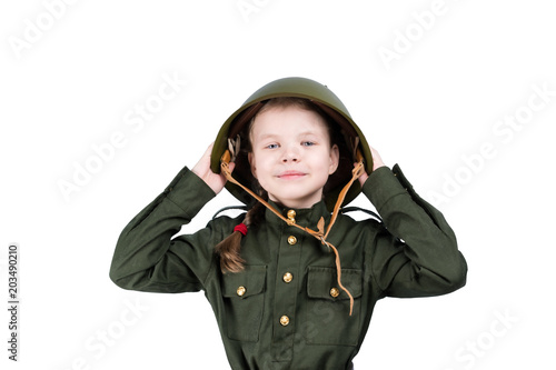 girl in military uniform holds a green helmet on her head, isolated on white
