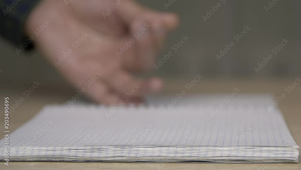 Close up flipping pages in notebook . Browsing blank pages in notebook Close up flipping pages in notebook . Browsing blank pages in notebook