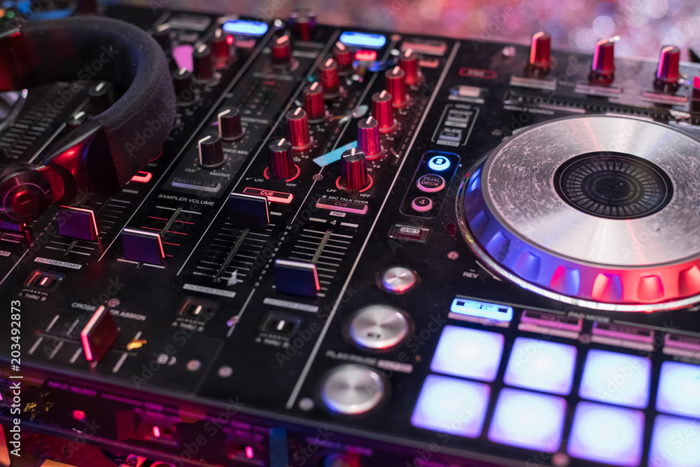 DJ is rhythm music with Controller and mixer. Stock Photo Adobe Stock