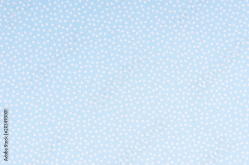Bright blue paper with white spots and dots texture background.