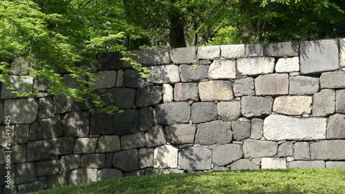 panning right clip of an ancient stone wall at the imperial palace east garden in tokyo, japan