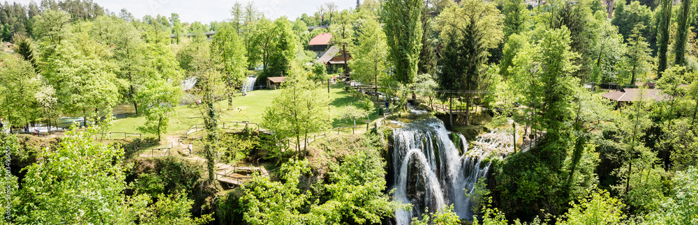 panoramic photo of Village of Rastoke by a Korana river with wooden houses and a waterfall in Croatia.
panoramic photo of Village of Rastoke by a Korana river with wooden houses and a waterfall in Croatia.