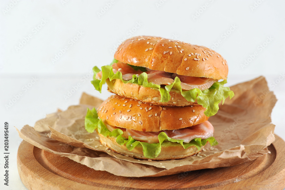 bagel with salmon slices and green salad bagel with salmon slices and green salad