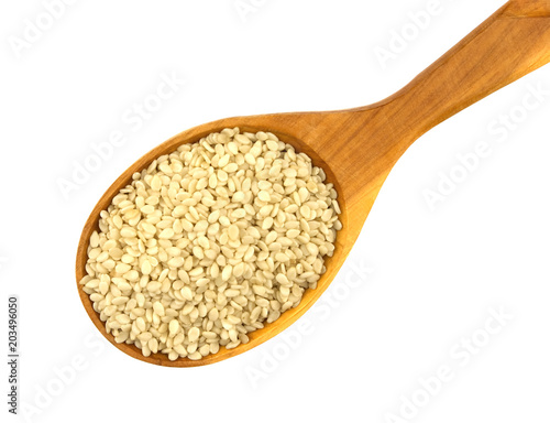 Peeled sesame seeds over white background