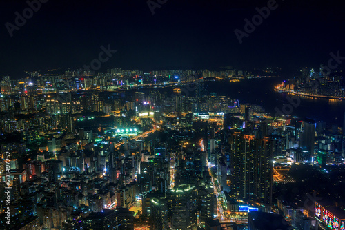 Cityscape of Kowloon with colourful lights in futuristic style