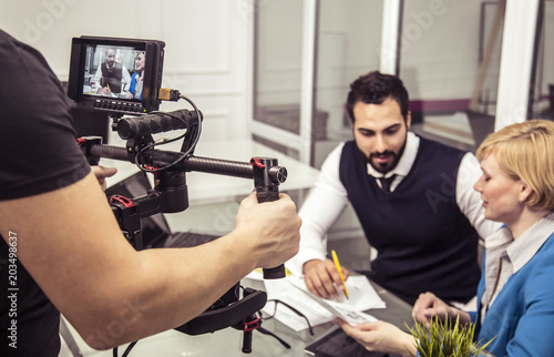 Backstage shot of two businessmans near table in white modern office photo