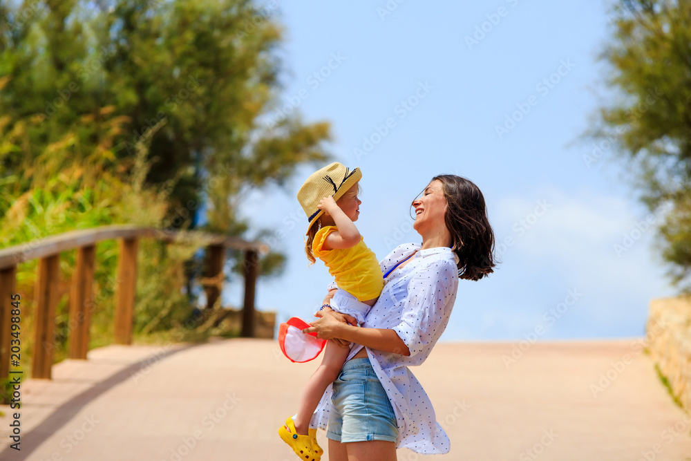 Obraz premium Cheerful woman holding kid. Happy mother with daughter.