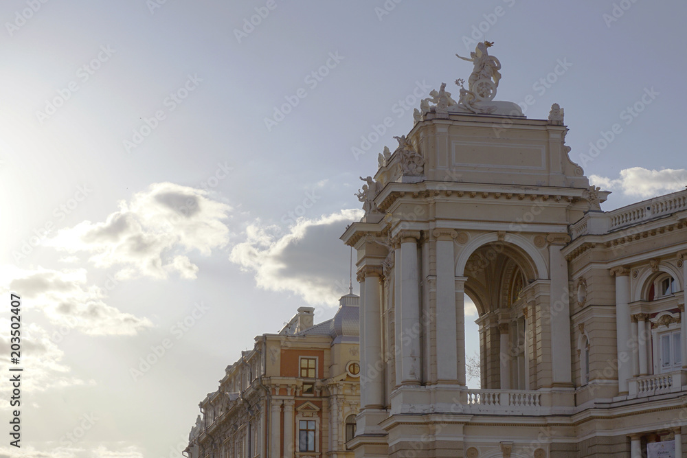 Old Opera and Ballet theatre in Europe, Ukraine, Odessa, with sunshine and blue cloudy sky.