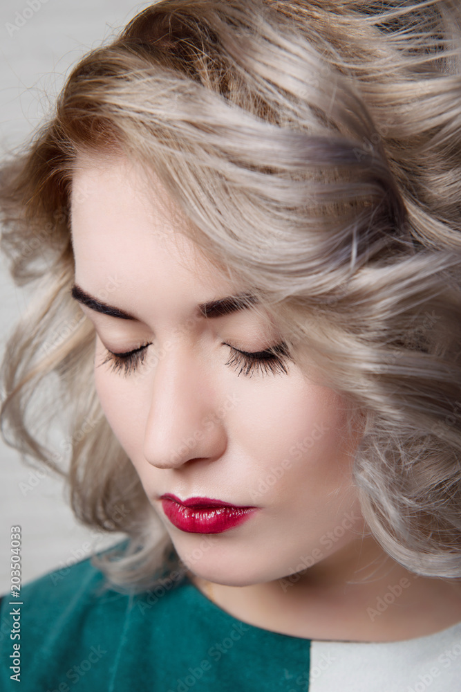 Makeup on closed eyes and a professional hairstyle on a blonde girl close-up. Makeup on closed eyes and a professional hairstyle on a blonde girl close-up.