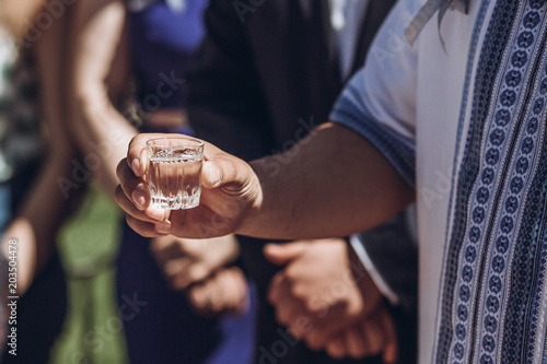 Fotografia, Obraz People drinking vodka during celebration hands closeup, wedding guests drinking
