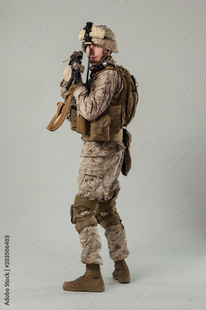 Soldier in camouflage holding rifle Soldier in camouflage holding rifle
