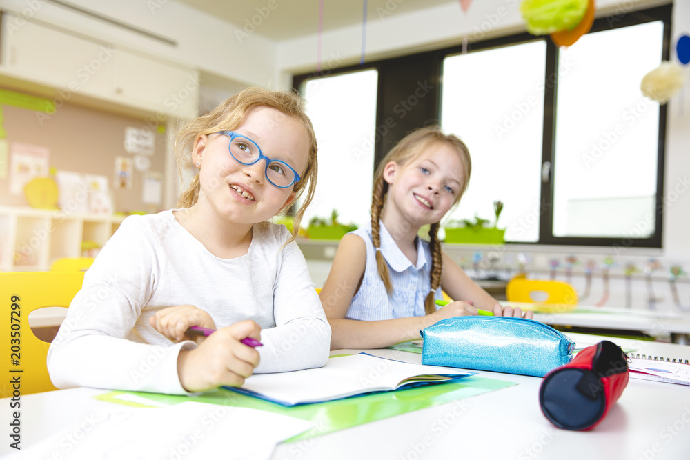 At School - Beautiful young kids have fun in school while learning in classroom At School - Beautiful young kids have fun in school while learning in classroom