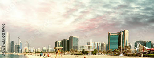 Abu Dhabi panoramic skyline at sunset as seen from Corniche Beach