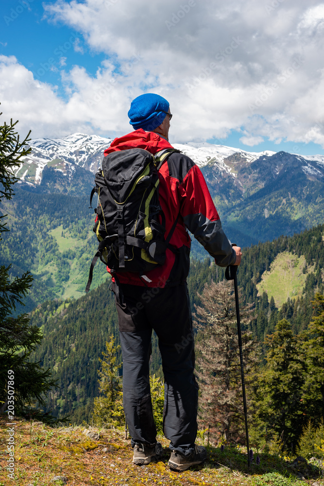 Adventurer with backpack delighted with the view Adventurer with backpack delighted with the view