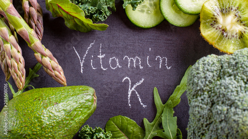 Green vegetables rich in vitamin K on black slate. photo