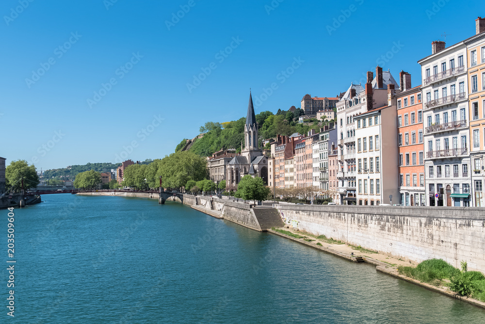 Naklejka premium Vieux-Lyon, Saint-Georges church on the quay, colorful houses and footbridge in the center, on the river Saone 
