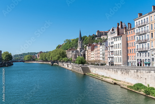 Vieux-Lyon, Saint-Georges church on the quay, colorful houses and footbridge in the center, on the river Saone 
