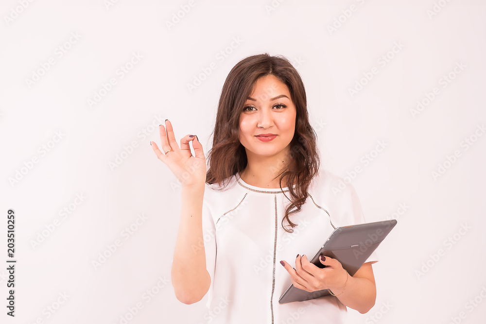A girl of Asian appearance holds a presentation. The style of the modern business woman. A girl of Asian appearance holds a presentation. The style of the modern business woman.