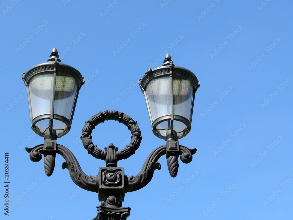 LED street lamp isolated on clear blue sky. Vintage lantern with modern lighting technology LED street lamp isolated on clear blue sky. Vintage lantern with modern lighting technology