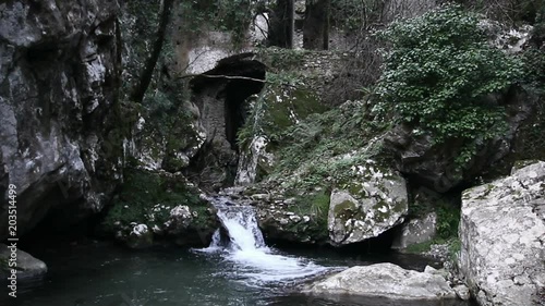 The river flows in the ruins of an ancient water mill in Ferriere Valley. photo