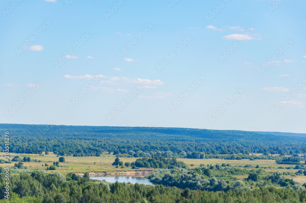 the picturesque landscape. the meadow and the river. the forest on the horizon