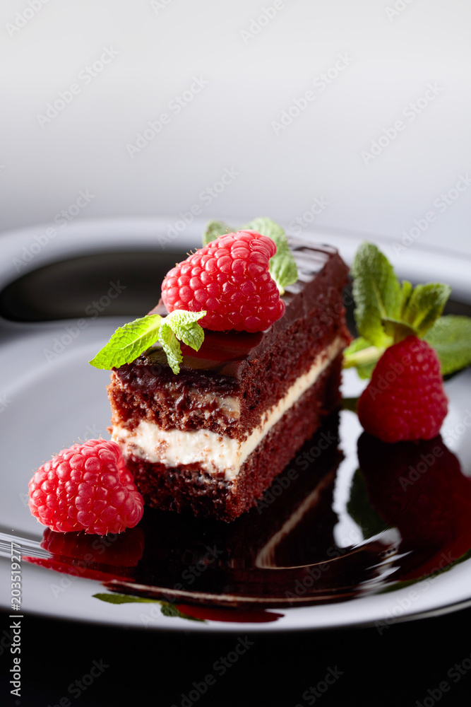Chocolate cake with raspberry and mint . Chocolate cake with raspberry and mint .